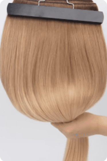 Blonde Remy hair extension held in hand