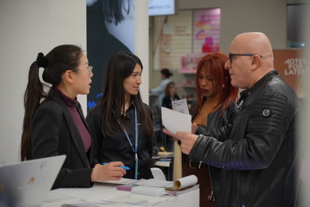ESSMEI representative speaking with a hair professional