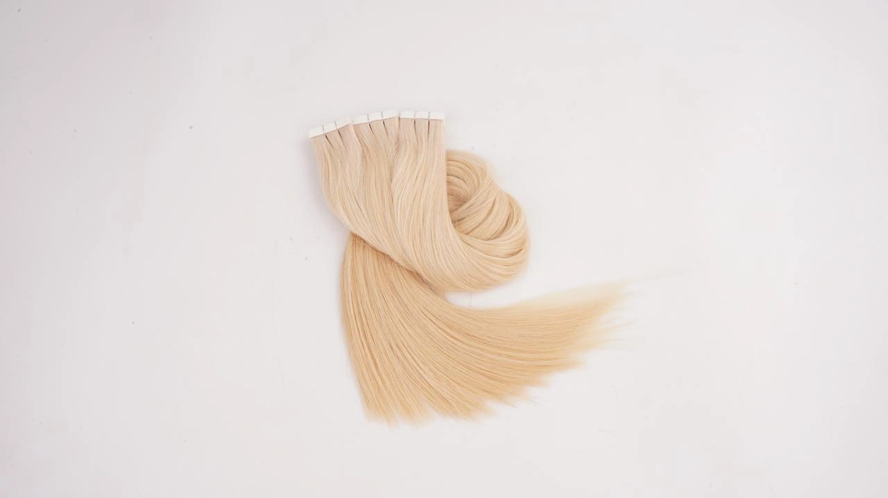 Blonde Tape-In human hair extensions with flat adhesive tabs for lightweight salon length and volume services