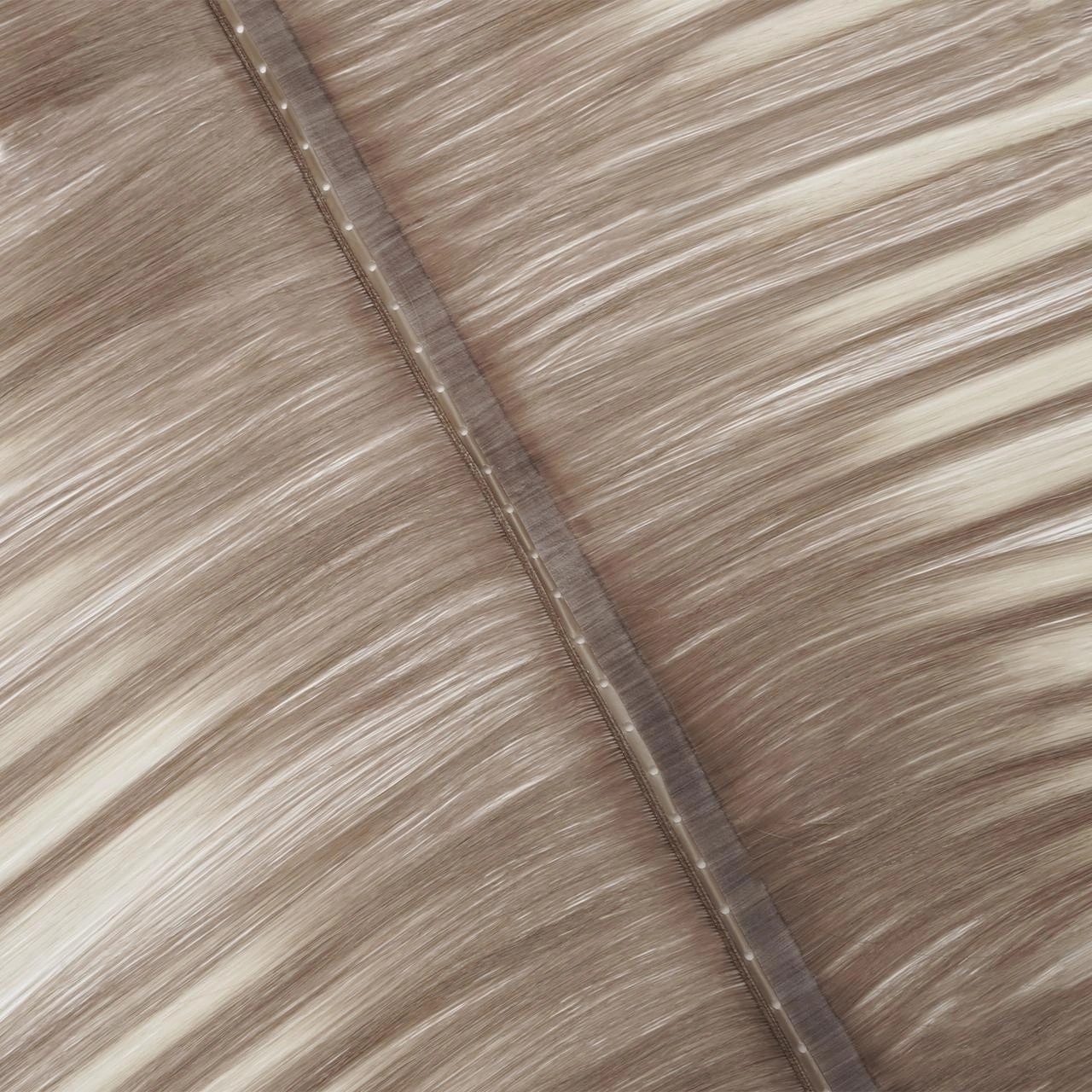 Close-up of a Genius Flip Weft with center-positioned bead holes, a narrow PU attachment area, and flexible Genius-style weft construction on both sides.