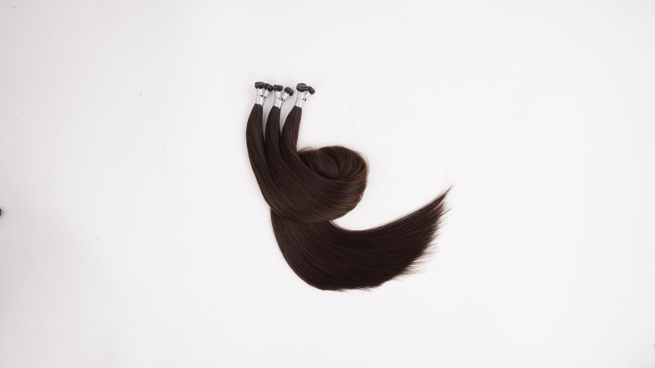 Dark brown Genius Weft human hair extensions for salon length, volume, and flat blending consultations