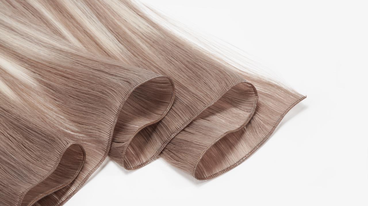 Genius Weft Remy human hair extensions showing ultra-thin flat weft edges for seamless salon installation